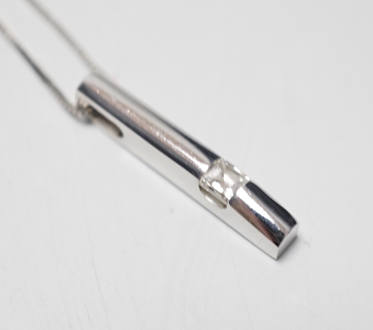 A modern 18ct white gold and solitaire diamond set pendant, 22mm, on an 18ct white gold fine link chain, 46cm, gross weight 4.1 grams.